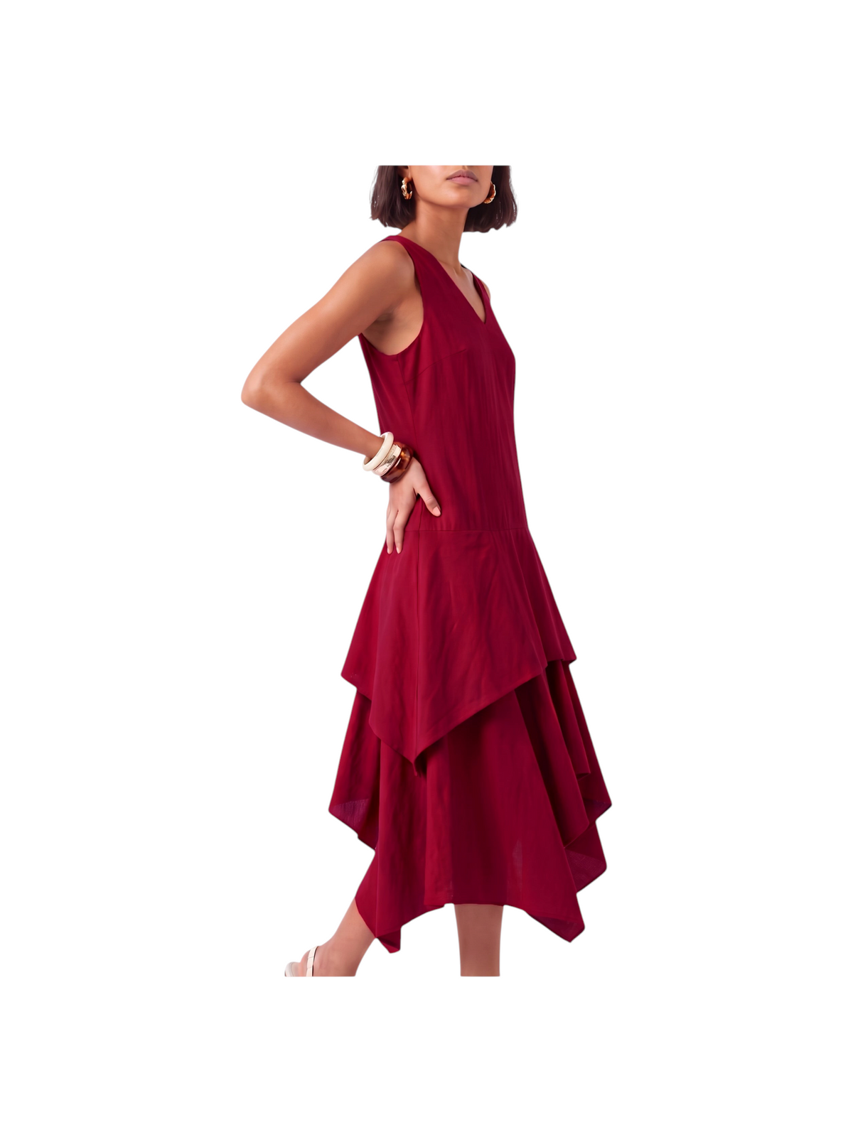 Model wearing a sleeveless deep red K/Woods Solstice Dress with a keyhole neckline and double-tiered handkerchief hem